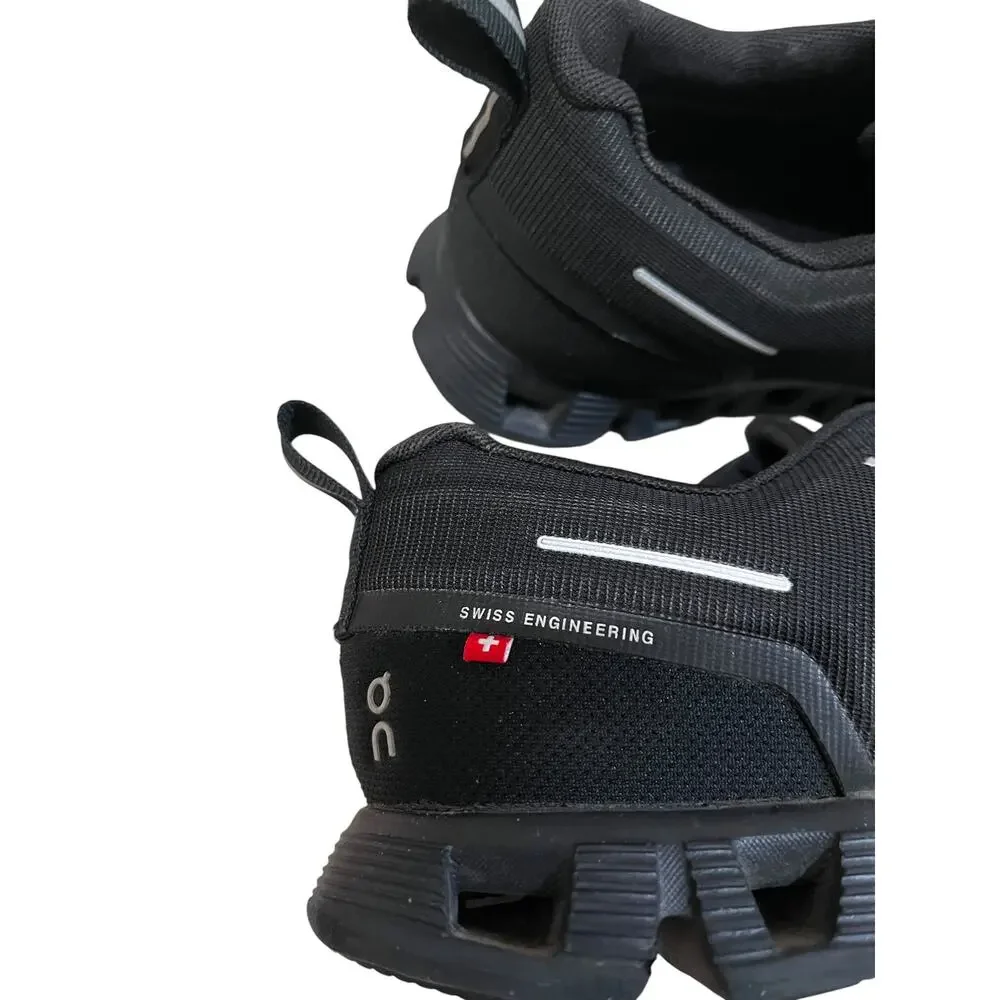 On Cloud waterproof running shoes for women in solid black.